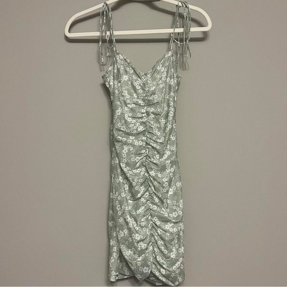 Light green body con ruched dress with white floral pattern